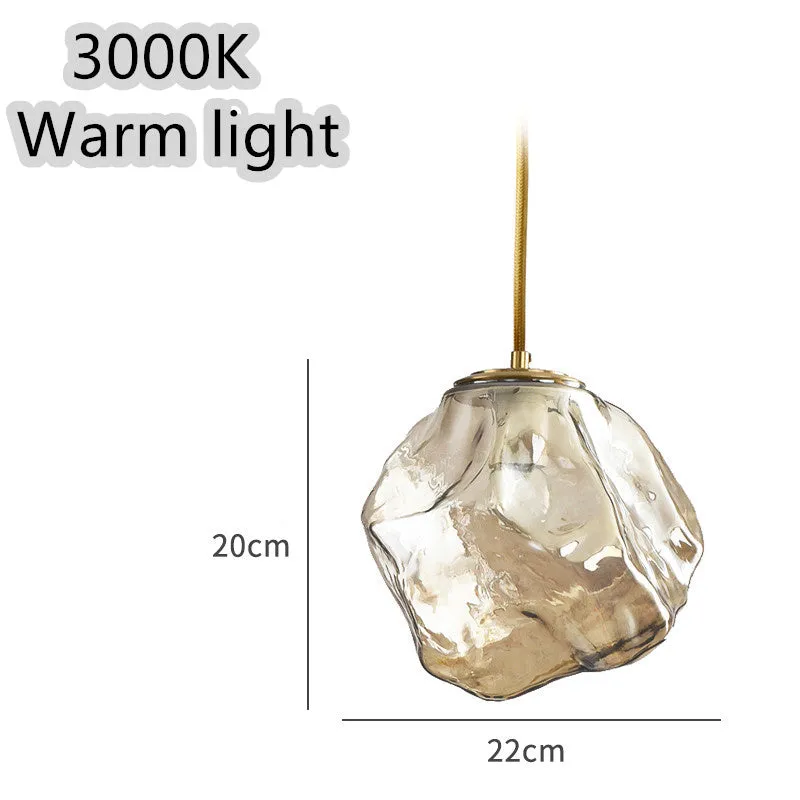 Minimalist ice cube glass chandelier with warm 4000K light, smoky grey shade and black hanging wire over a dining table