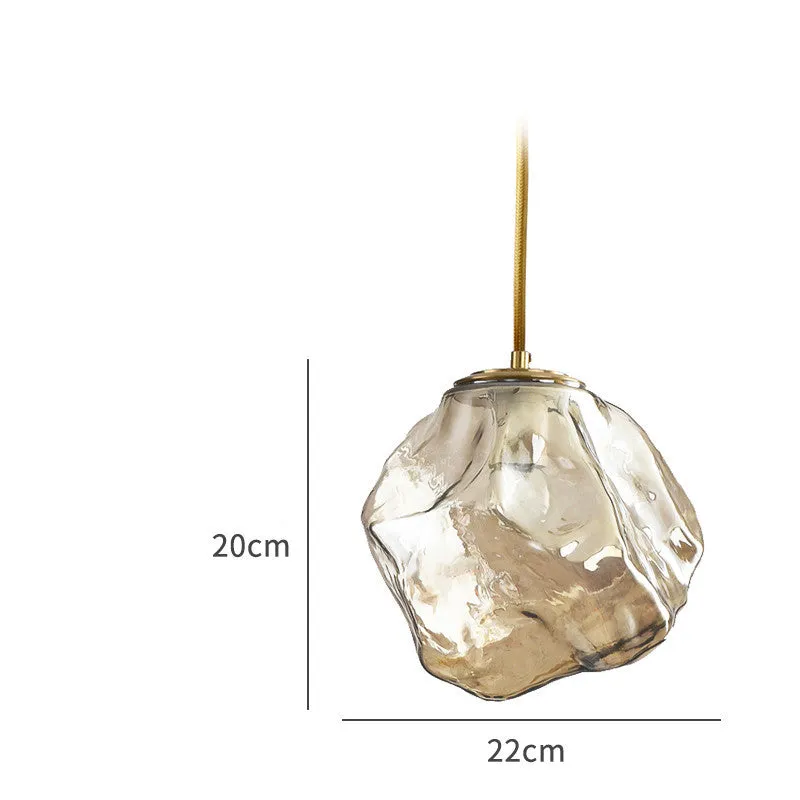 Minimalist ice cube glass chandelier with warm 4000K light, smoky grey shade and black hanging wire over a dining table