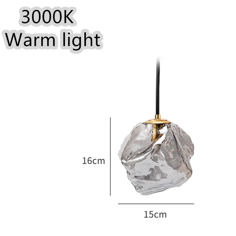 Minimalist ice cube glass chandelier with warm 4000K light, smoky grey shade and black hanging wire over a dining table