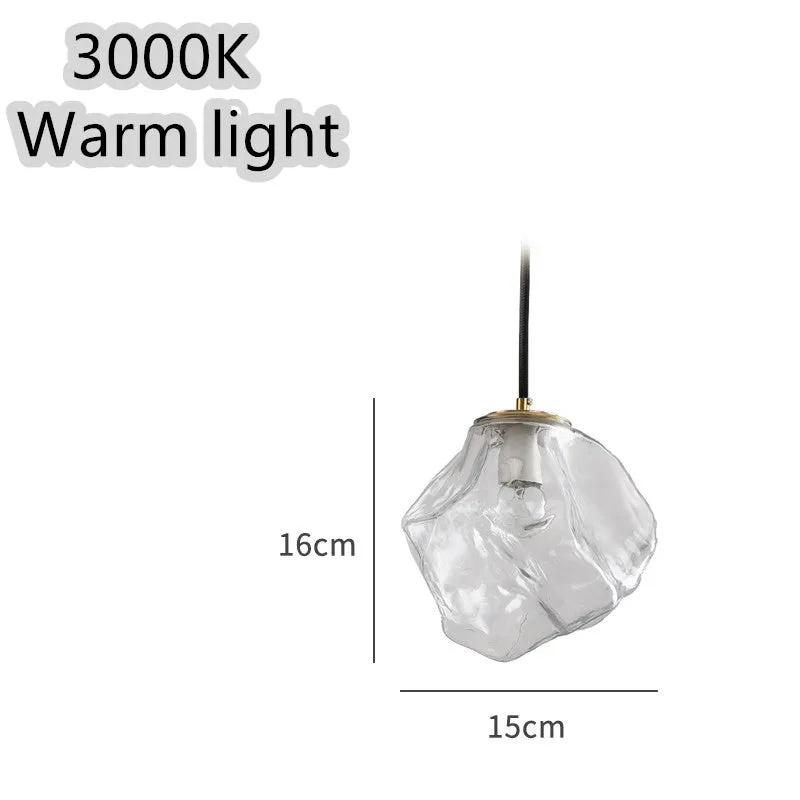 Minimalist ice cube glass chandelier with warm 4000K light, smoky grey shade and black hanging wire over a dining table