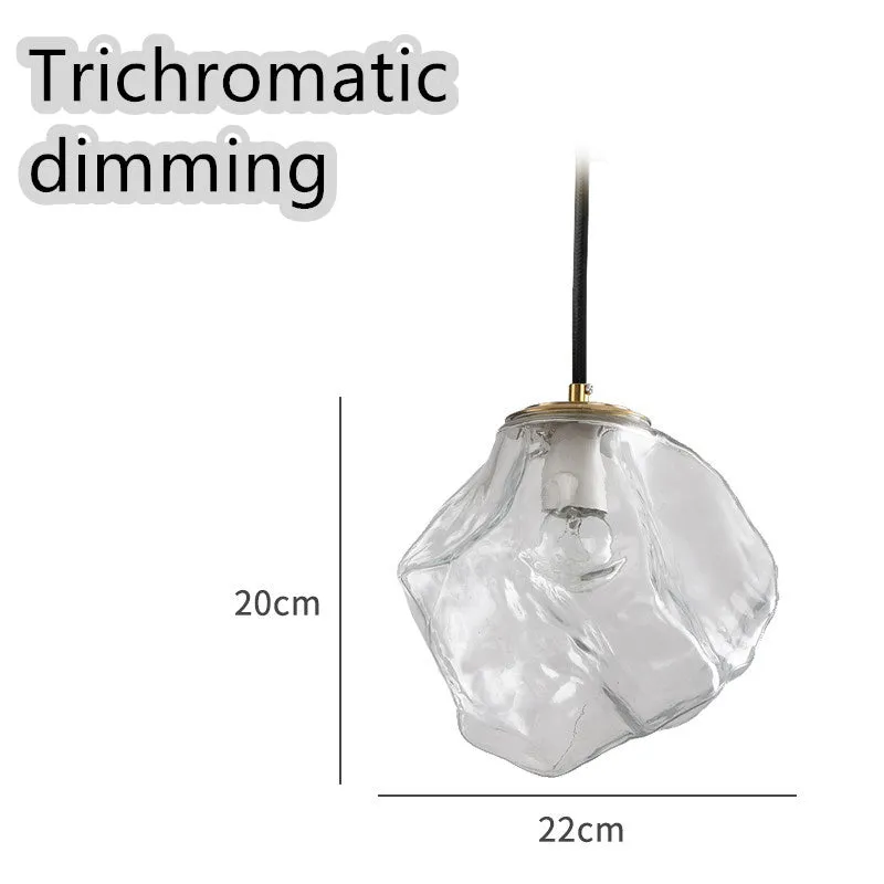 Minimalist ice cube glass chandelier with warm 4000K light, smoky grey shade and black hanging wire over a dining table