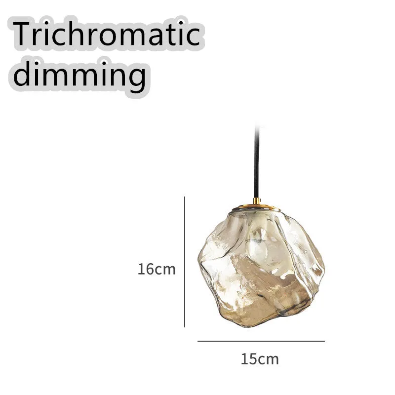 Minimalist ice cube glass chandelier with warm 4000K light, smoky grey shade and black hanging wire over a dining table