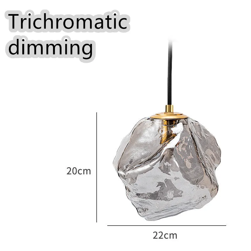 Minimalist ice cube glass chandelier with warm 4000K light, smoky grey shade and black hanging wire over a dining table