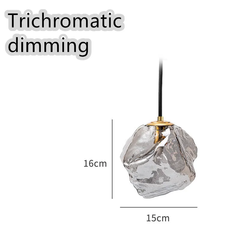 Minimalist ice cube glass chandelier with warm 4000K light, smoky grey shade and black hanging wire over a dining table