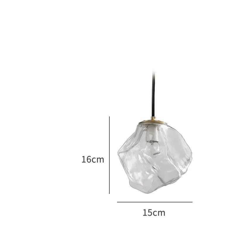 Minimalist ice cube glass chandelier with warm 4000K light, smoky grey shade and black hanging wire over a dining table