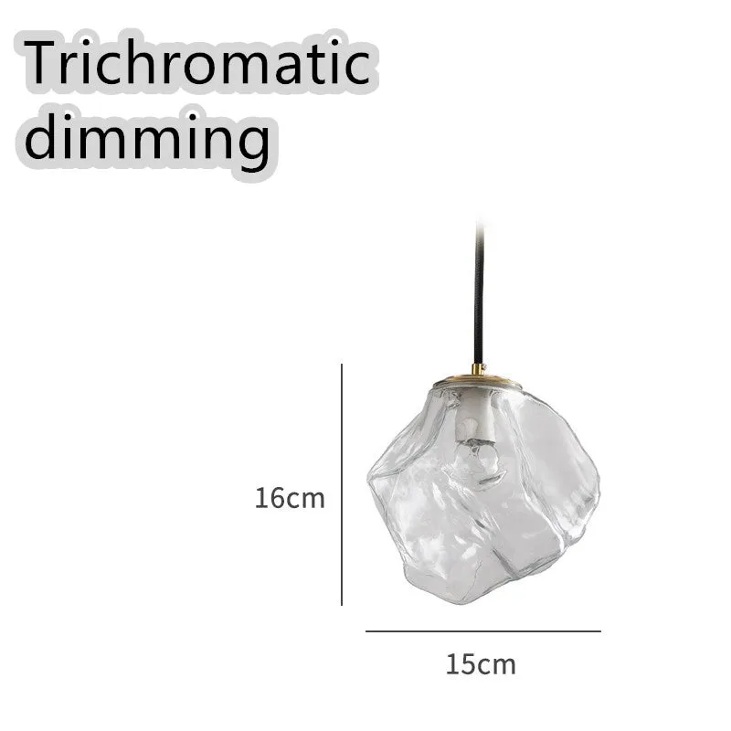 Minimalist ice cube glass chandelier with warm 4000K light, smoky grey shade and black hanging wire over a dining table