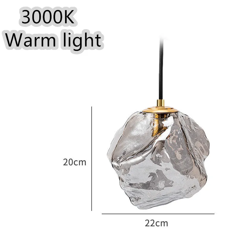 Minimalist ice cube glass chandelier with warm 4000K light, smoky grey shade and black hanging wire over a dining table