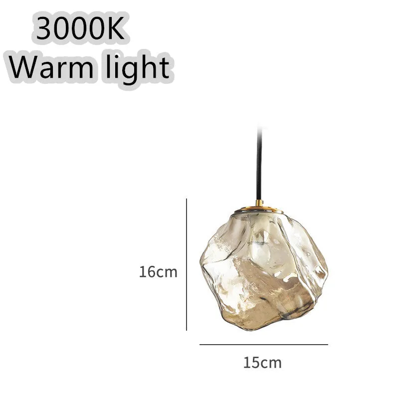 Minimalist ice cube glass chandelier with warm 4000K light, smoky grey shade and black hanging wire over a dining table