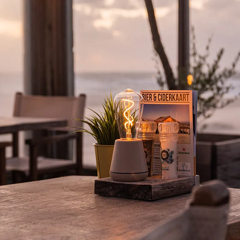 Portable LED camping lantern with aluminium body and 3-speed adjustable brightness in outdoor setting