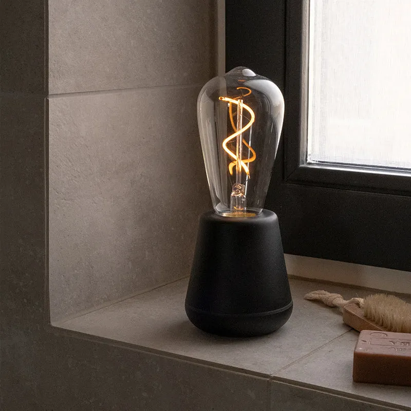 Portable LED camping lantern with aluminium body and 3-speed adjustable brightness in outdoor setting