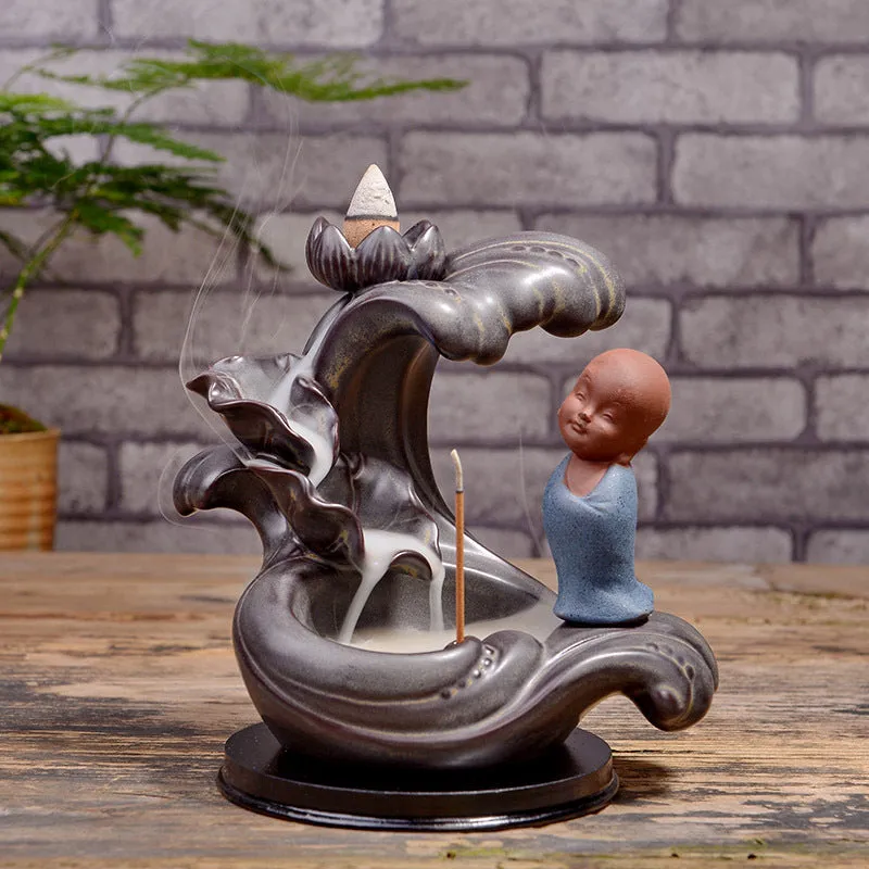 Ceramic backflow incense burner in Zen Lotus Pond Yellow with traditional pottery finish on a wooden table