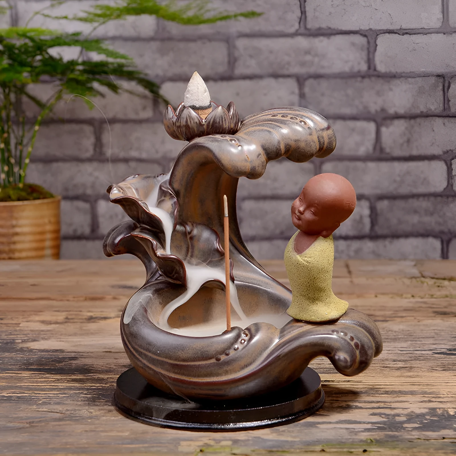 Ceramic backflow incense burner in Zen Lotus Pond Yellow with traditional pottery finish on a wooden table