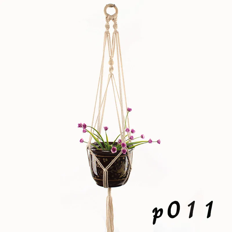 A rustic-style woven cotton rope plant trellis panel supporting green leaves.