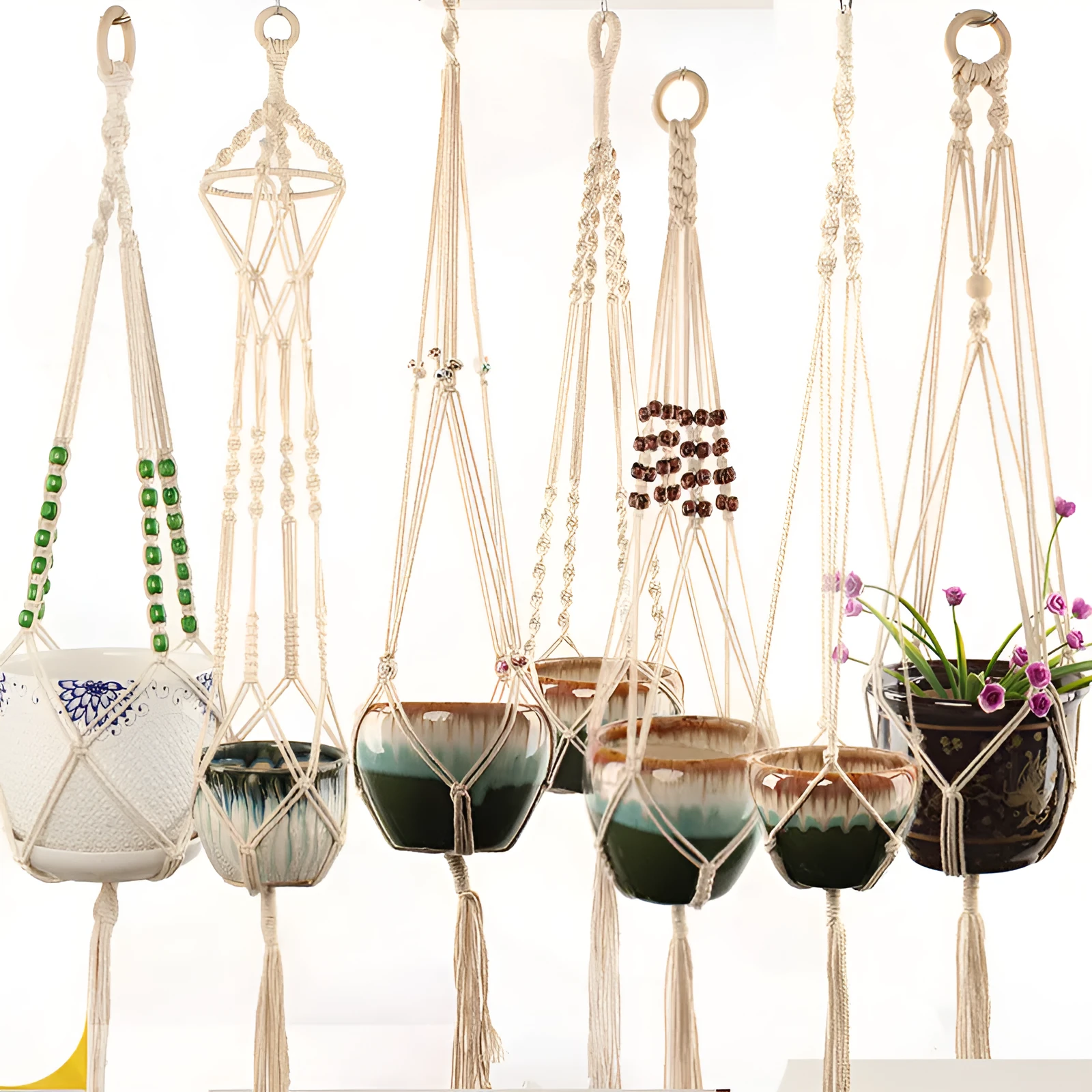 A rustic-style woven cotton rope plant trellis panel supporting green leaves.