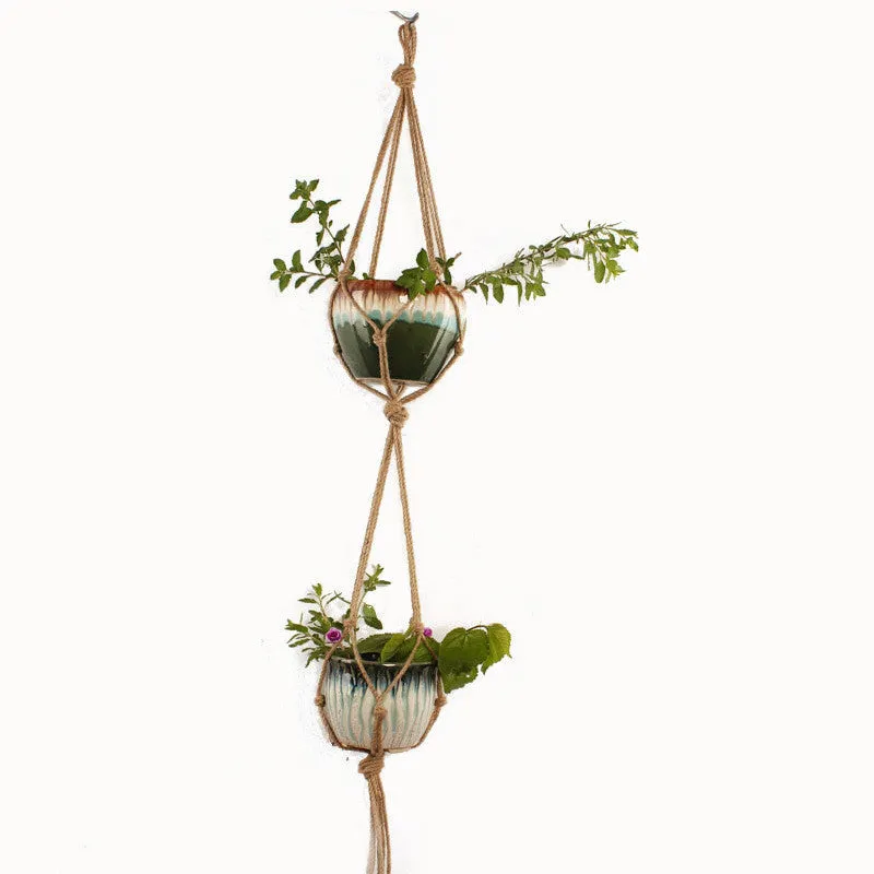 A rustic-style woven cotton rope plant trellis panel supporting green leaves.
