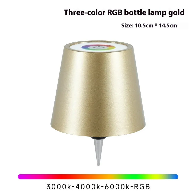 Plug-in wine bottle lamp with RGB tricolour dimming in wrought iron black finish on a table