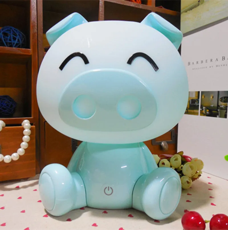Cartoon pig small night lamp in blue showing soft LED glow, ABS body with USB power connection