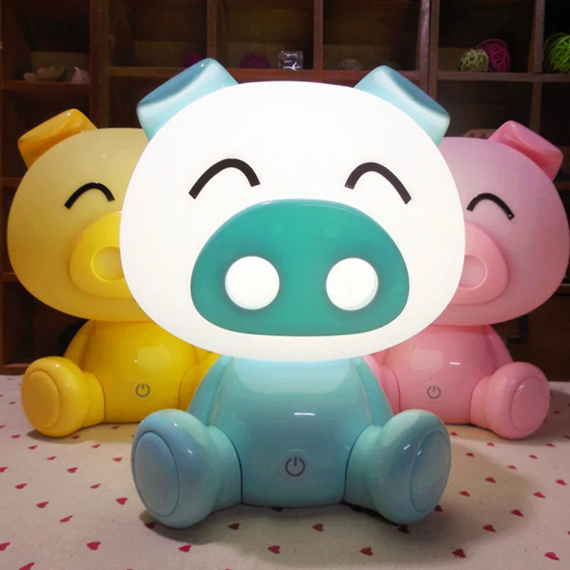 Cartoon pig small night lamp in blue showing soft LED glow, ABS body with USB power connection