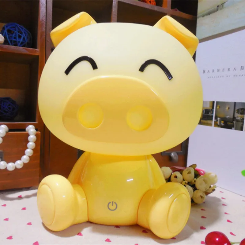 Cartoon pig small night lamp in blue showing soft LED glow, ABS body with USB power connection