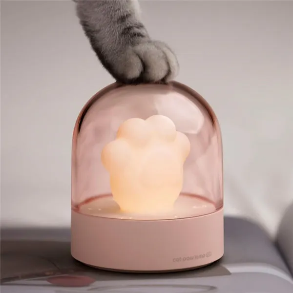 Grey and pink cat paw shaped USB rechargeable night light with rotating dynamic lighting
