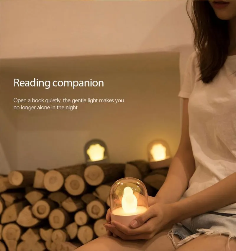 Grey and pink cat paw shaped USB rechargeable night light with rotating dynamic lighting