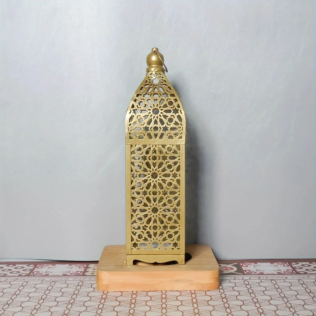 Gold L decorative iron barn lantern with hollow four-corner design on a tabletop
