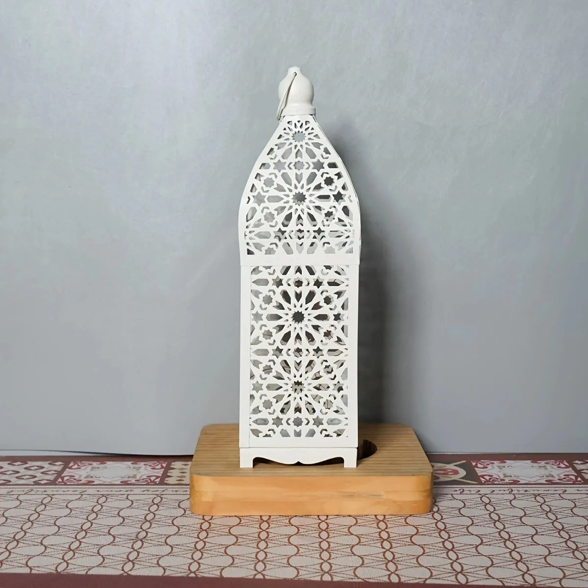 Gold L decorative iron barn lantern with hollow four-corner design on a tabletop