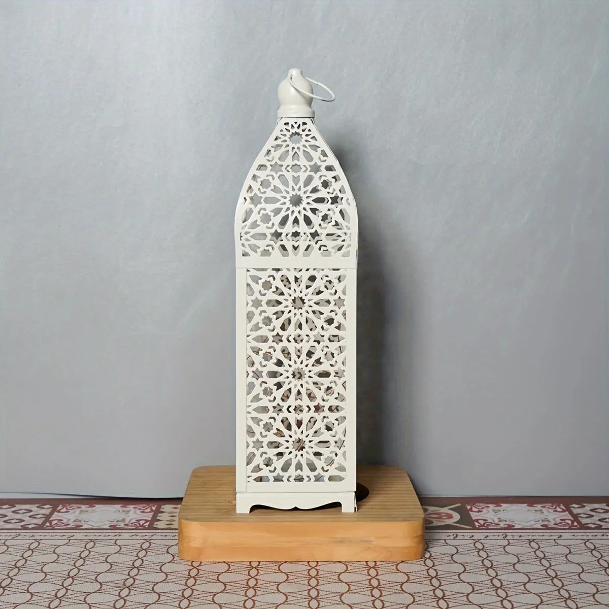 Gold L decorative iron barn lantern with hollow four-corner design on a tabletop