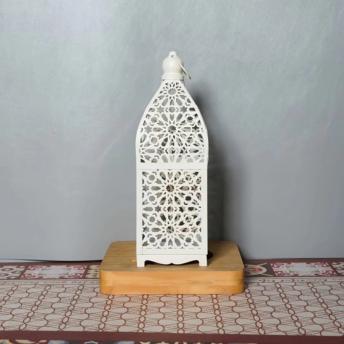 Gold L decorative iron barn lantern with hollow four-corner design on a tabletop