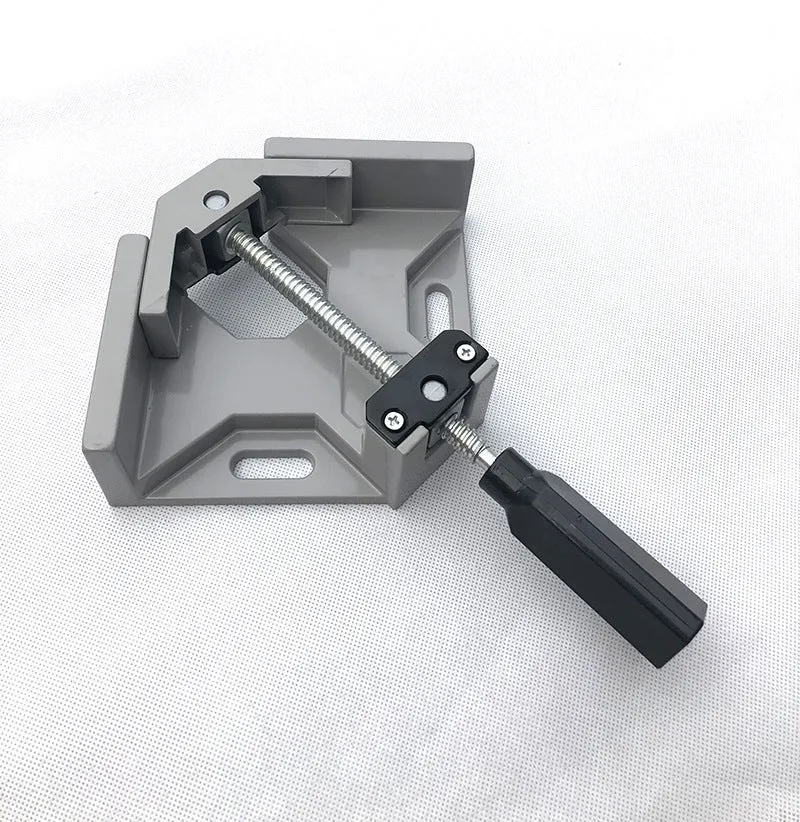 Black aluminium alloy 90 degree right angle clip with 70mm opening on a wooden workbench.