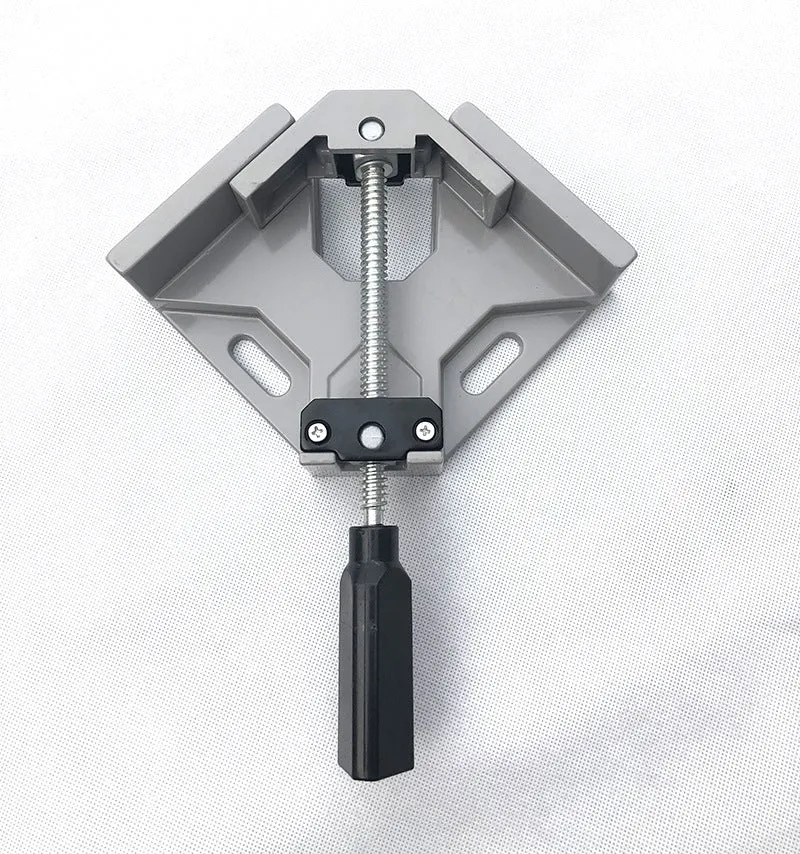 Black aluminium alloy 90 degree right angle clip with 70mm opening on a wooden workbench.