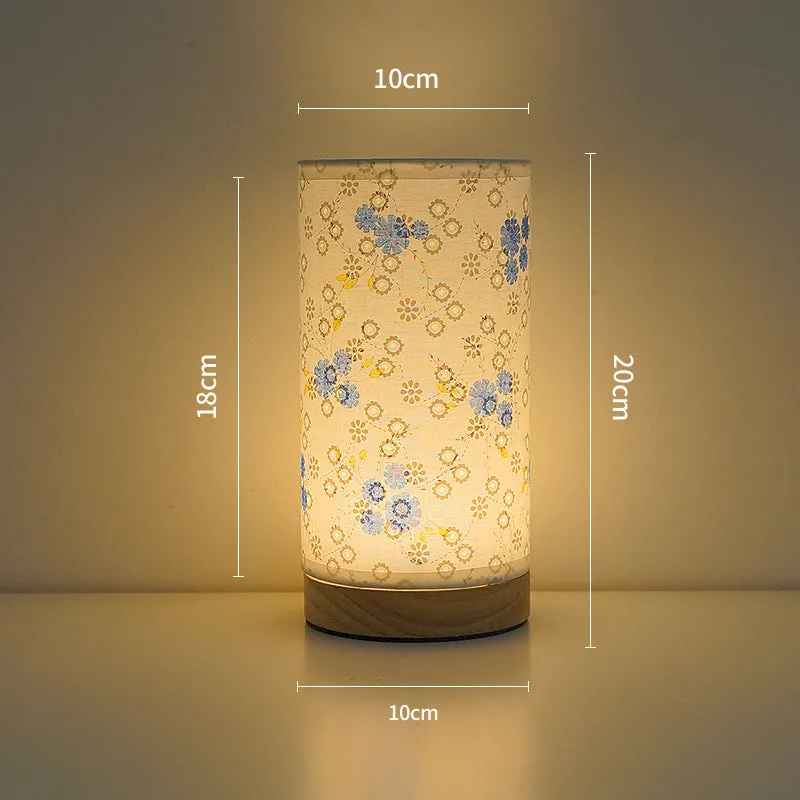 Creative USB table lamp with fabric shade in blue butterfly pattern on modern desk
