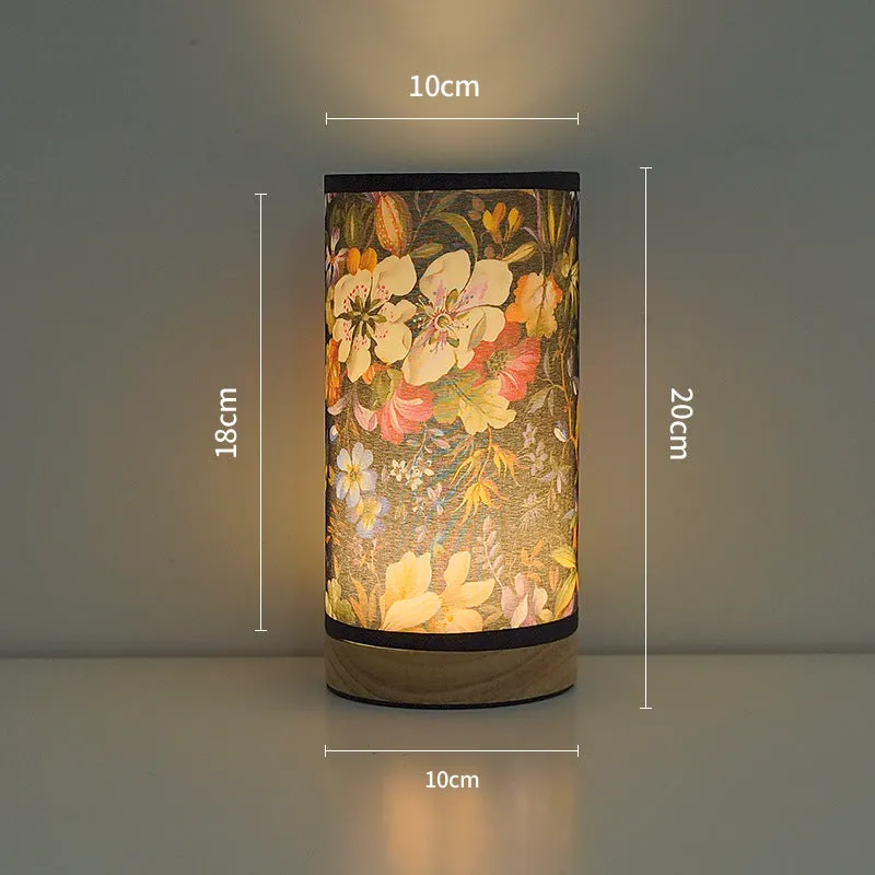 Creative USB table lamp with fabric shade in blue butterfly pattern on modern desk