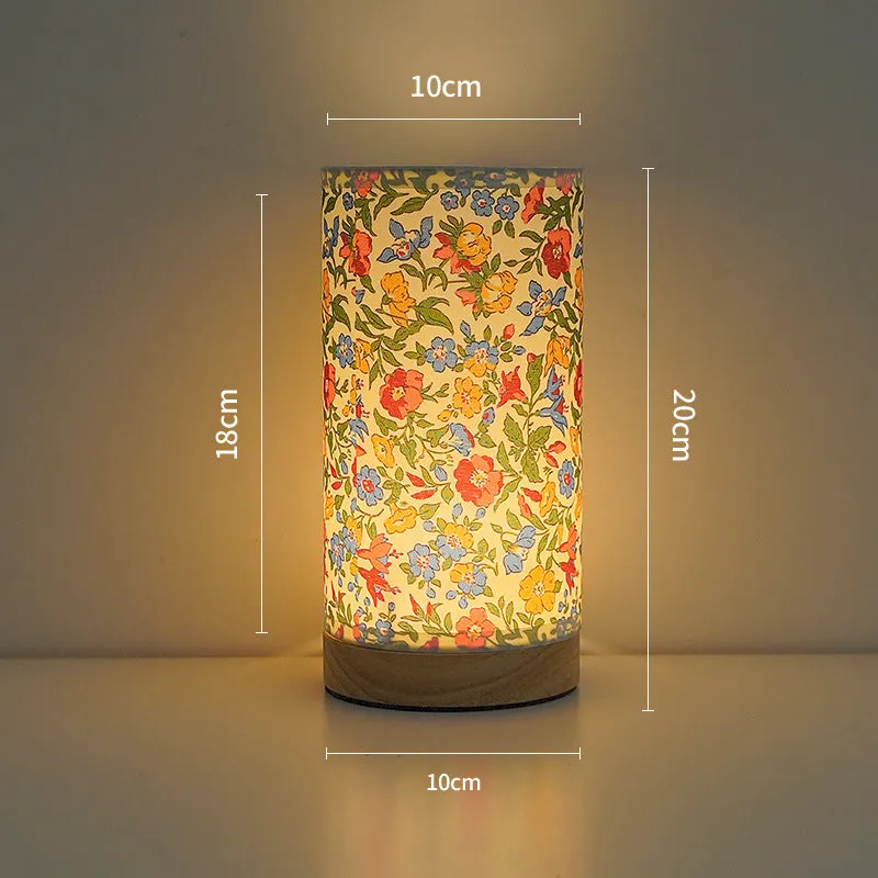 Creative USB table lamp with fabric shade in blue butterfly pattern on modern desk