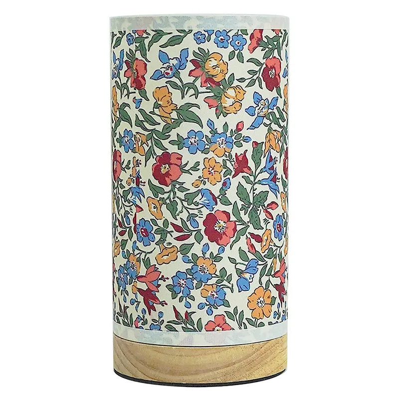 Creative USB table lamp with fabric shade in blue butterfly pattern on modern desk