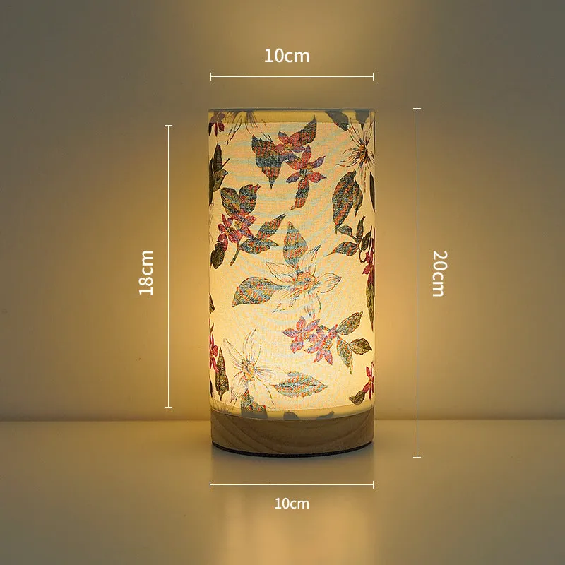 Creative USB table lamp with fabric shade in blue butterfly pattern on modern desk