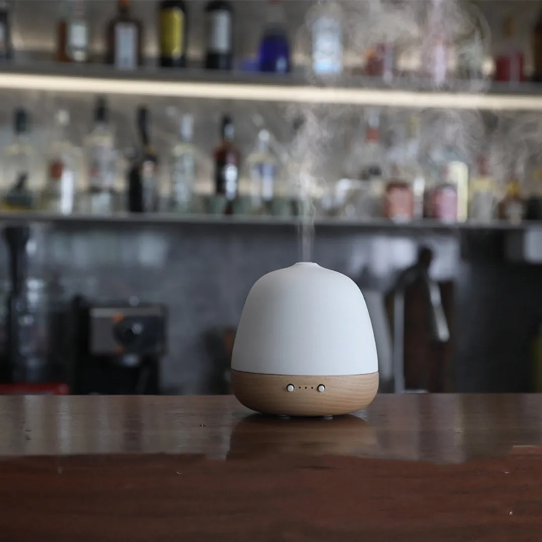 White ceramic ultrasonic essential oil humidifier with 180ml capacity on a table top