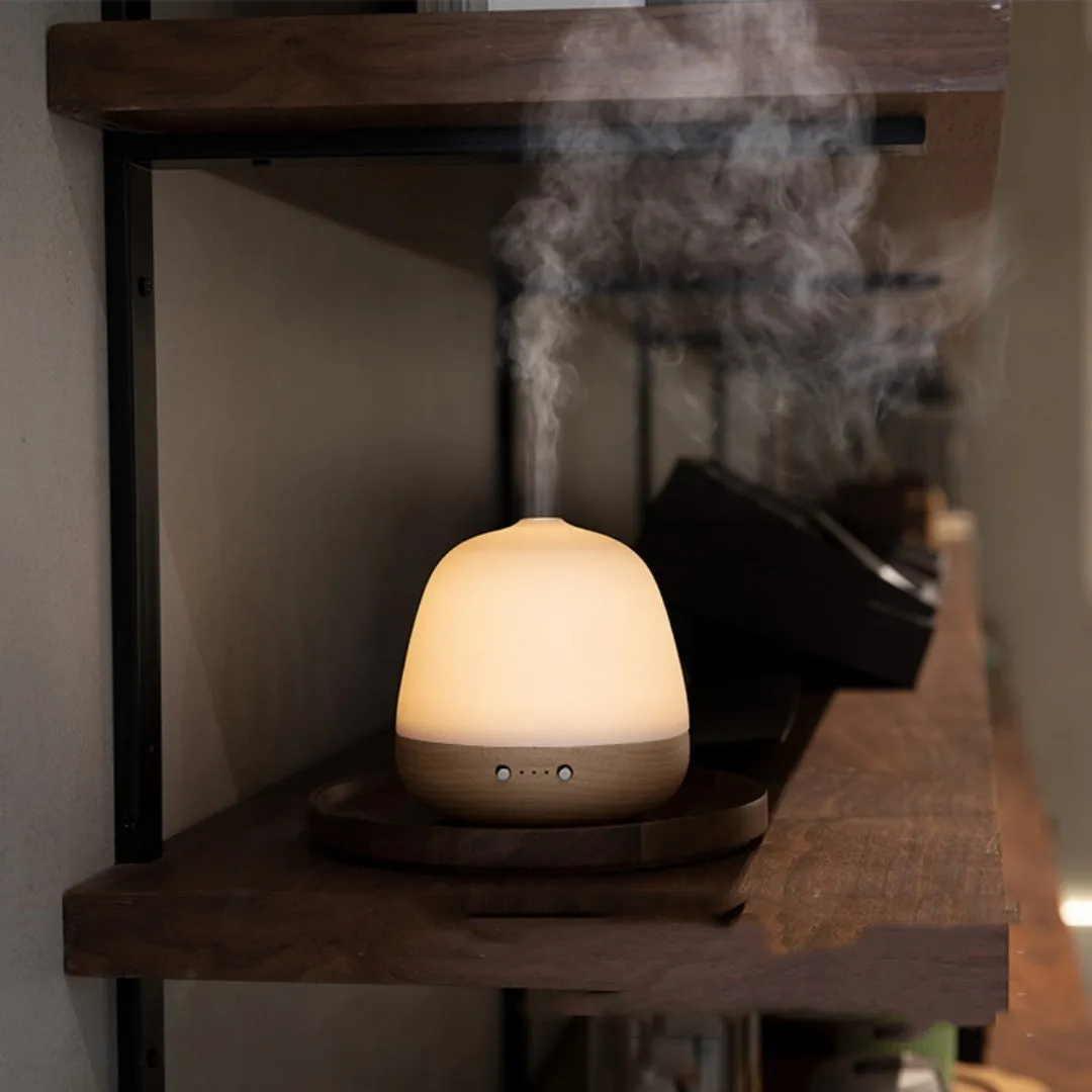 White ceramic ultrasonic essential oil humidifier with 180ml capacity on a table top