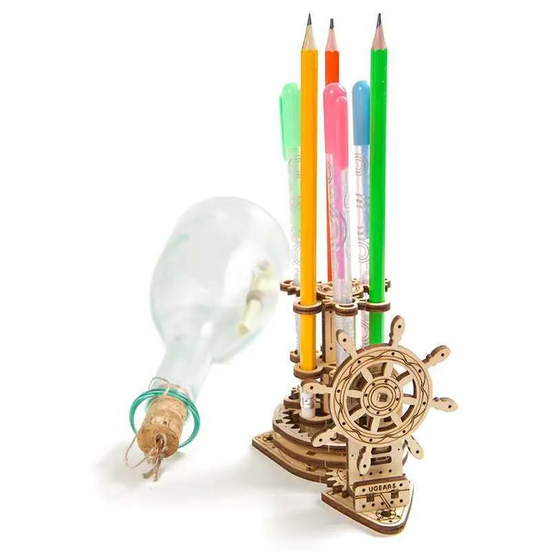 Ukrainian wooden rotating machinery model pen holder on a desk.