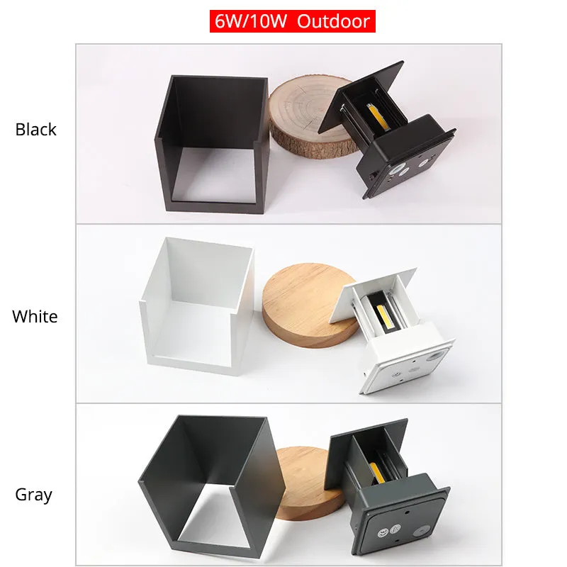 Black aluminium square wall lamp mounted on a corridor wall, showing 100mm size and 360-degree light emission.