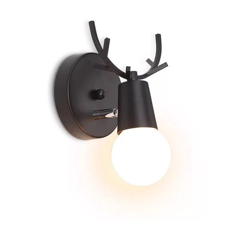 Wrought iron wall lamp with wooden antler-style shade on a white wall