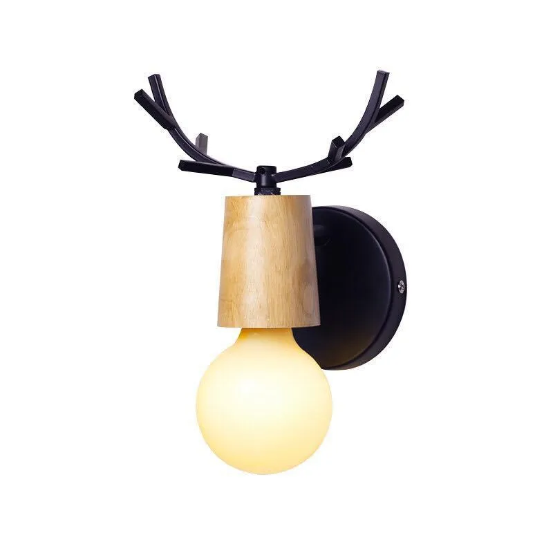Wrought iron wall lamp with wooden antler-style shade on a white wall