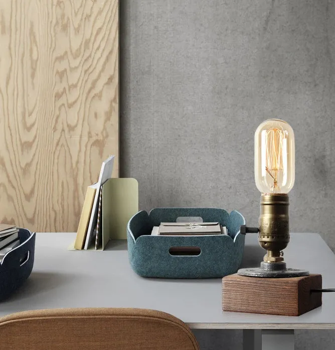 Compact wooden and iron water pipe style table lamp on a surface