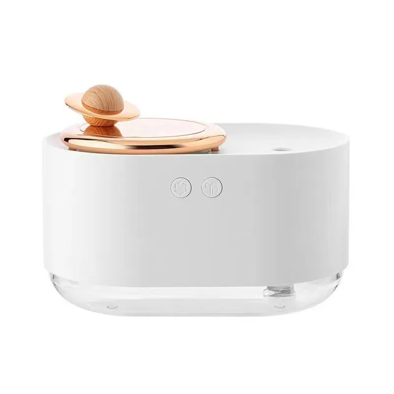 Green rotating planet humidifier with USB cable on desk showing night light illumination