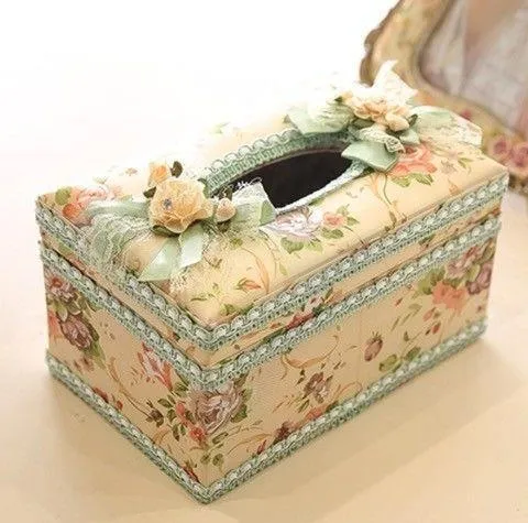 Ceramic jewellery and tissue storage box in bright apricot colour on a table.