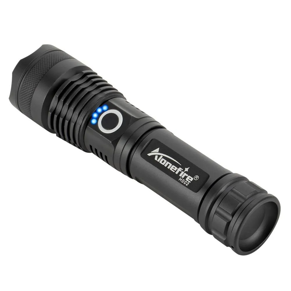Black aluminium alloy LED flashlight with zoom lens on plain background