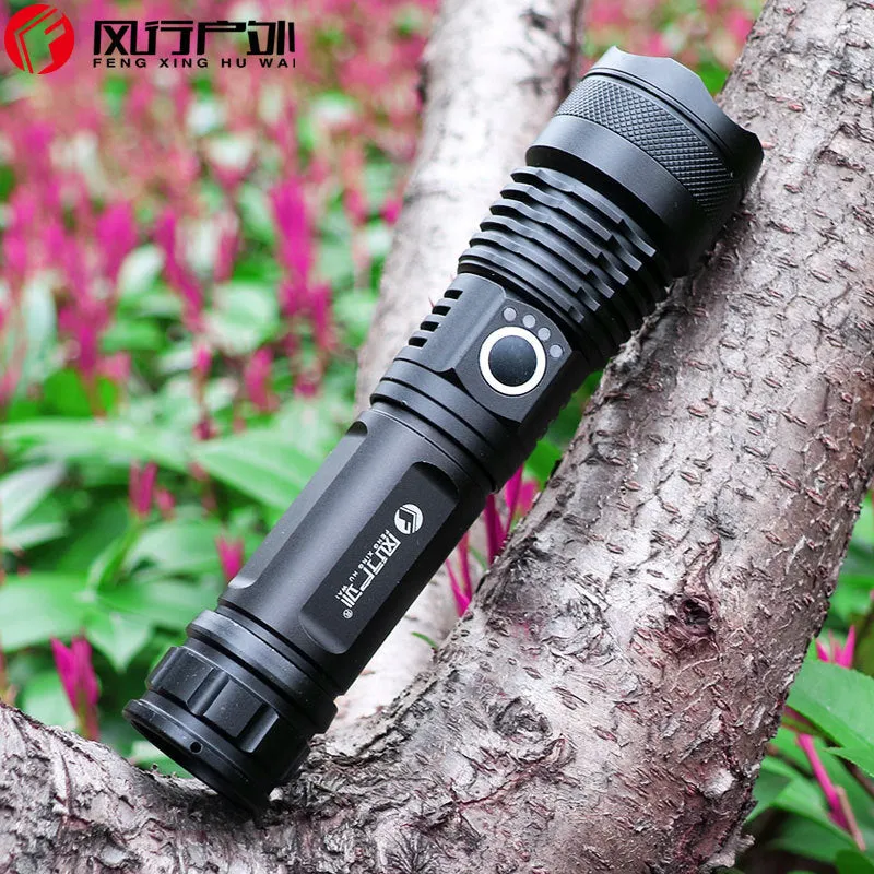 Black aluminium alloy LED flashlight with zoom lens on plain background