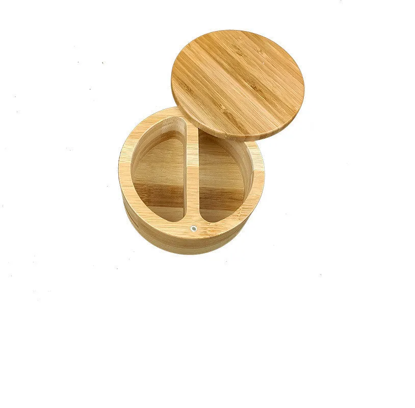 Bamboo seasoning storage box with a small bamboo spoon on a kitchen counter.