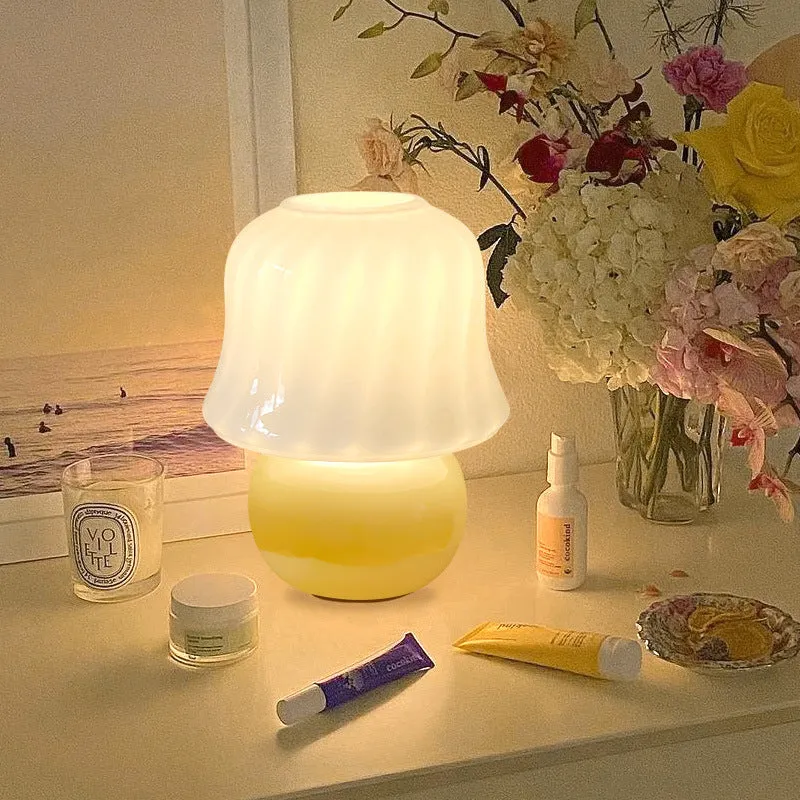 Handmade glazed glass mushroom lamp in cream yellow with push button switch on bedside table