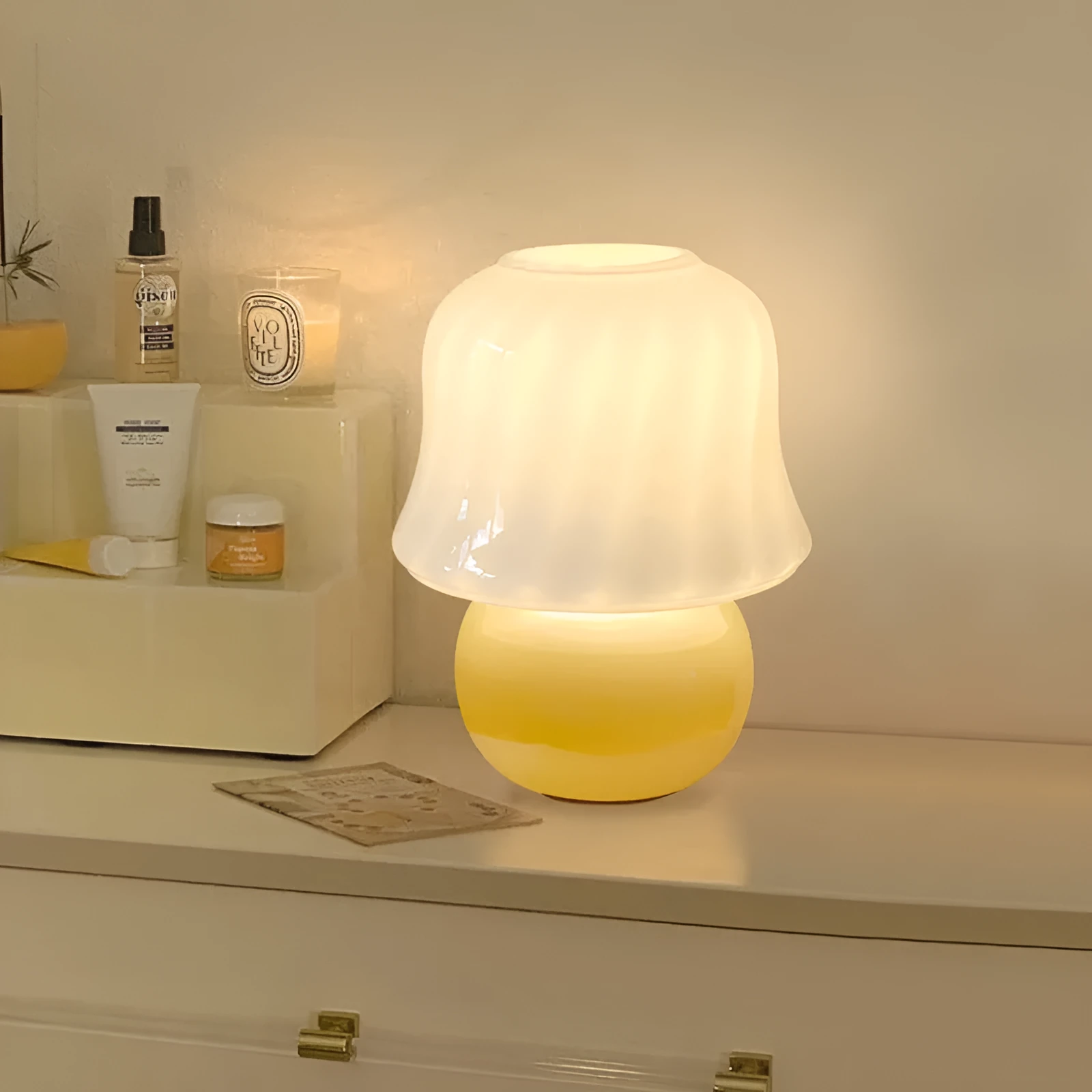 Handmade glazed glass mushroom lamp in cream yellow with push button switch on bedside table